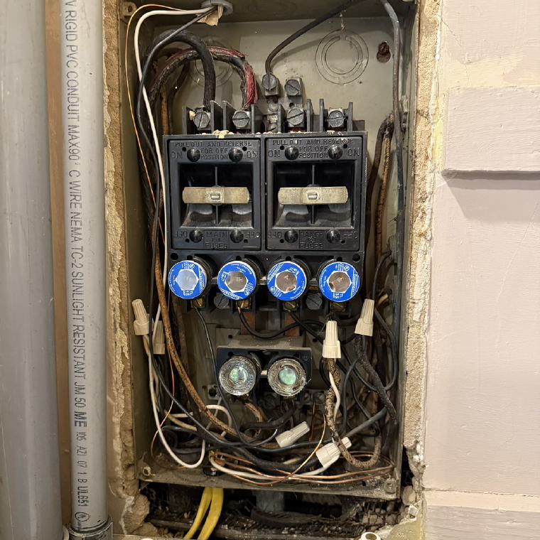 Deteriorated fuse panel with pull-out fuse blocks and aged cloth-covered conductors