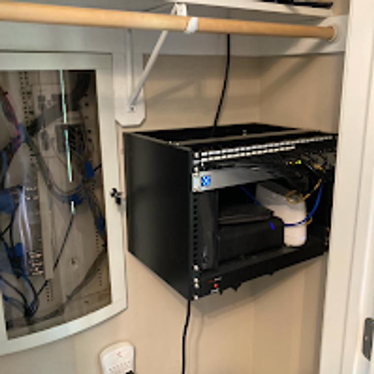 Structured wiring rack and media enclosure mounted in a home closet