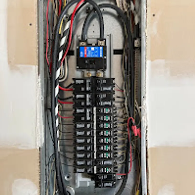 Open residential load center showing breakers, feeders and neutral terminations