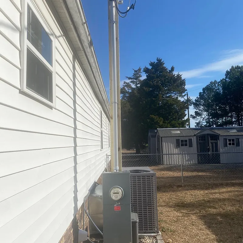 Exterior service riser, meter base and disconnect installed on a home